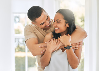 Image showing Couple, hug and smile in home for love, care and relax for romance, support and trust of bond together. Happy man, woman and hugging partner for quality time, happiness and commitment to relationship