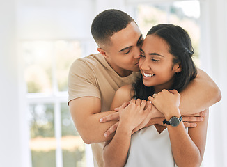 Image showing Couple, hug and kiss in home for love, care and relax for romance, support and trust of bonding together. Happy man hugging young woman, partner and kissing for quality time, happiness or anniversary