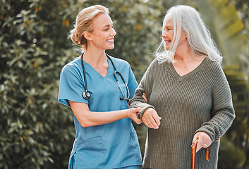 Image showing Support, care and caregiver walking senior woman in a garden to relax, wellness and morning exercise in the lawn. Trust, nursing home and nurse help elderly person happy and smile for an outdoor walk