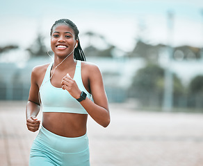 Image showing Portrait, outdoor and black woman running, exercise and training for wellness, health and self care. Face, female person or runner with earphones, workout goal and athlete with music, smile or cardio