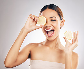 Image showing Woman, lemon and studio portrait for skin health, wellness and facial glow by white background. Girl, model and healthy skincare with youth, makeup and cosmetics for self care, funny face and excited