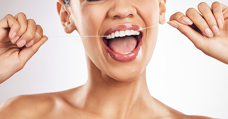 Image showing Smile, dental and woman flossing teeth in studio for hygiene, wellness or fresh breath on grey background. Hands, floss and lady relax with mouth, tooth or cleaning for oral care or cavity prevention