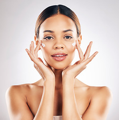 Image showing Skincare, portrait and face cream for woman in studio with healthy, glowing or anti aging beauty on grey background. Facial, hands and female model relax with dermatology, sunscreen and lotion