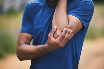 Image showing Sports, fitness and man with pain in elbow after workout, exercise and marathon training outdoors. Medical emergency, health and male person with muscle strain, arm injury and joint ache in park