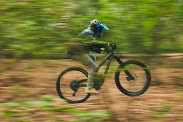 Image showing Motion blur, mountain bike and person cycling in forest for adventure, speed and fast power. Athlete, extreme sports and bicycle for outdoor action, off road transport and cardio race for adrenaline