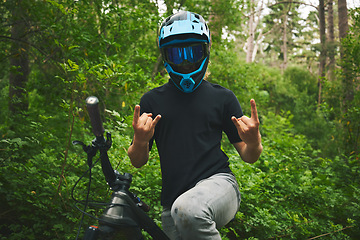 Image showing Mountain bike, nature and man with rock on sign for freedom, adventure and forest racing. Bicycle athlete, sports and hands with horn gesture for action, off road competition or emoji of race winner