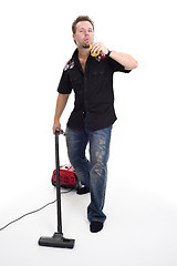 Image showing Man with vacuum cleaner and beer