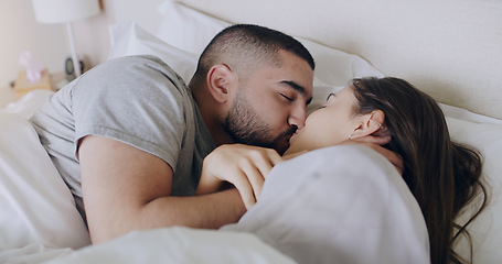 Image showing Couple, kiss and bedroom for love, care and romance of intimacy, special moment and quality time together at home. Man, woman and kissing partner for relationship, honeymoon and relax in the morning