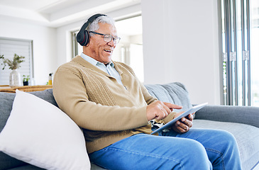 Image showing Old man laughing, relax with tablet and headphones at home, retirement and technology, streaming comedy online. Surfing internet, watching funny video and elderly male person sitting on couch