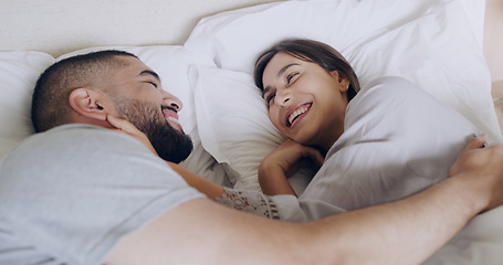 Image showing Face, happy woman and relax with man in bed, room and enjoy romance of quality time together at home. Couple, relationship and laughing in morning for love, care and happiness of partner on honeymoon