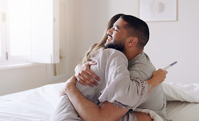 Image showing Couple, hug and happy for pregnancy test in bedroom, home and support to celebrate good news. Excited man, woman and partner hugging in celebration of pregnant results, future family or ivf fertility