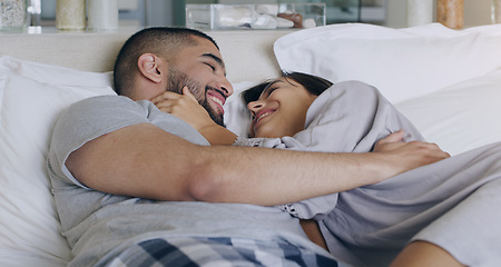 Image showing Couple, love and smile in bed, bonding and romance of intimacy, special moment and trust together at home. Happy young man, woman and partner in relationship, honeymoon and relax for care in bedroom