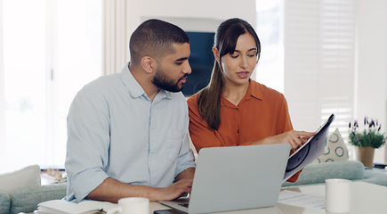 Image showing Laptop, documents and couple planning bills, debt or mortgage payments together in the living room. Technology, financial paperwork and young man and woman paying with online banking in their home.