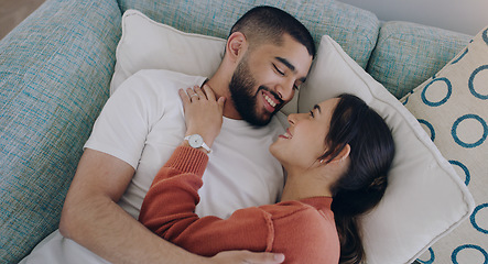 Image showing Top view of happy couple, love and hug on sofa in living room for romance, intimacy and relax together at home. Young man, woman and cuddle partner on couch for relationship, quality time and care