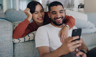 Image showing Home, sofa and couple with phone online for social media, browse website or internet news. Communication, love and happy man and woman on smartphone for quality time, bonding and relax in living room