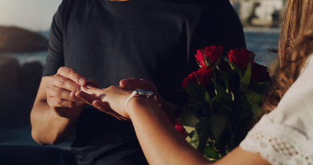 Image showing Love, proposal and engagement with hands of couple in outdoor for marriage, commitment or trust. Wedding ring, roses and jewelry with closeup of man and woman for announcement, celebration and fiance
