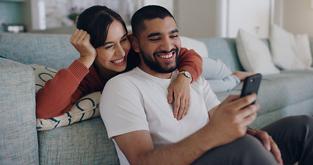 Image showing Couple, phone and laughing at meme on social media or internet joke and relax in a living room couch in a home. Sofa, cellphone and people streaming online comedy on a smartphone in a house together