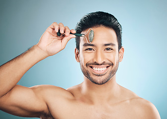 Image showing Happy man, portrait or face massage with roller, facial product for healthy skincare on studio background. Relaxing, grooming treatment or male model smiling with dermatology cosmetics for beauty