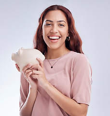 Image showing Finance, portrait or happy woman with a piggy bank for financial wealth or savings on white background. Smile, investment or girl laughing or investing cash or budget in tin for safety or security