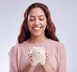 Image showing Finance, portrait or happy girl with a piggy bank for financial wealth or savings on white background. Smile, investment or woman smiling or investing cash or budget in tin for safety or security