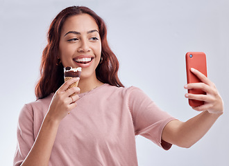 Image showing Girl, ice cream and selfie with smile in studio for summer vacation, social media app and blog by white background. Woman, gelato or dessert with photography, profile picture and happy by backdrop