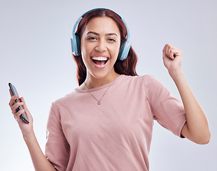 Image showing Mobile, portrait or happy woman in headphones dancing music or radio audio in studio on white background. Dance, singing or girl streaming or listening to song playlist in freedom with cellphone