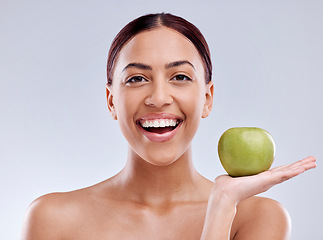 Image showing Apple, portrait or happy woman in studio eating on white background for healthy nutrition or clean diet. Smile, hand or excited girl showing natural organic green fruits for wellness or digestion