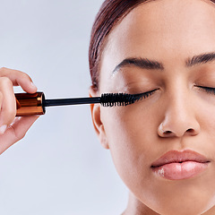 Image showing Eyelash extension, beauty or girl with mascara makeup, cosmetics or product brush for grooming in studio. Face or closeup of woman with eyelashes tool for make up or self care on white background