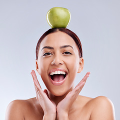 Image showing Apple, balance or portrait of excited woman in studio on white background for healthy nutrition or clean diet. Smile, wow or happy girl advertising or marketing a natural green fruit for wellness