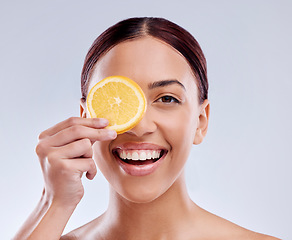 Image showing Skincare, portrait or happy girl with orange or natural facial with citrus or vitamin c on studio background. Wellness, smile or healthy woman smiling with organic fruits for dermatology beauty