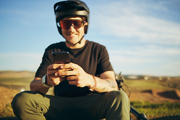 Image showing Biker, outdoor and man with a smartphone, typing and connection for social media, network and communication. Male person, cyclist or guy with a cellphone, mobile app and texting with sms and chatting