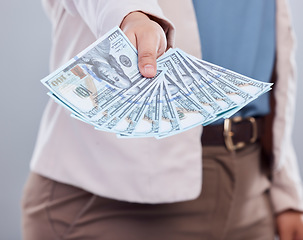 Image showing Money, offer and woman hands isolated on a studio background for winning, cash success or finance loan. Lottery, banking and business person or winner giving bonus, wealth or financial profit choice