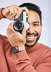 Image showing Happy man with camera, photography and smile in portrait with creativity and art isolated on studio background. Male photographer, creative with artistic person and taking pictures with gadget