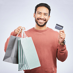 Image showing Man with smile, shopping bag and credit card with retail, discount and commercial isolated on white background. Customer, finance and Asian male person with payment for purchase, luxury and sale