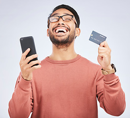 Image showing Man is excited, smartphone and credit card, online shopping and bonus with success on studio background. Happy customer experience, ecommerce and fintech, male person celebrate winning and sale