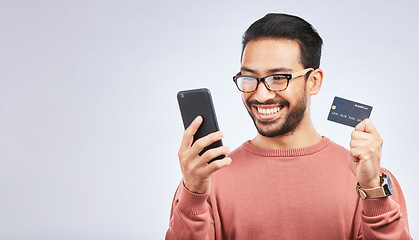 Image showing Happy man, smartphone and credit card for online shopping, discount or promo isolated on studio background. Positive customer experience, ecommerce and fintech, male person and sale with mockup space