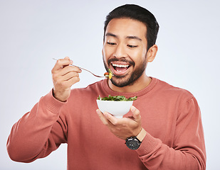 Image showing Man is eating salad, healthy food and nutrition with diet, detox and vegetables isolated on studio background. Health, wellness and vitamins with hungry male person, eat meal and lose weight