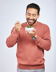 Image showing Man is eating salad, healthy food and lose weight with nutrition, detox and vegetables isolated on studio background. Health, wellness and vitamins with hungry male person, eat meal and diet