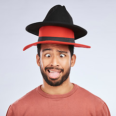 Image showing Silly, hats and goofy man in a studio with a crazy, funny and comic face expression or pose. Comedy, happy and Mexican male person with fun head accessories and humor isolated by a white background.