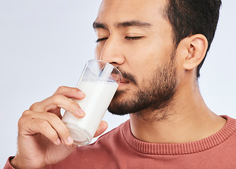 Image showing Man drinking milk, health and nutrition with calcium, vitamins and wellness isolated on white background. Dairy product in glass, beverage and male person with healthy diet for strong bones in studio