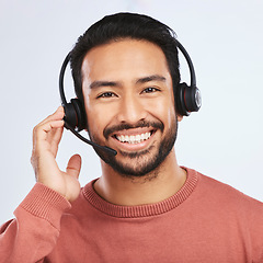 Image showing Man with headset, call center and contact us in portrait, smile and communication on studio background. Customer service, telemarketing and tech support with male consultant at help desk job