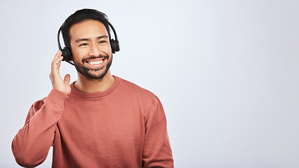 Image showing Man with headset, call center and contact us with smile, mockup space and communication on studio background. Customer service, telemarketing and tech support with male consultant and help desk job