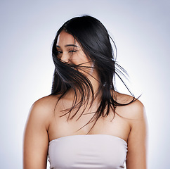 Image showing Shake head, happy and woman with hair care, beauty and volume against a studio background. Female person, excited girl and model with salon treatment, grooming and self care with flip and wind