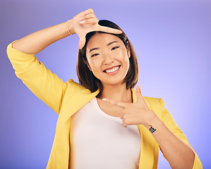 Image showing Portrait, frame and Asian woman with a smile, selfie and happy against a studio background. Face, female person or photographer with hand gesture, moment and creative perspective and finger framing