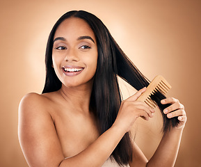 Image showing Smile, woman brush her for hair treatment and against a studio background with a glow. Self care, health wellness and cheerful or excited isolated young female person brushing against backdrop