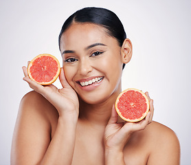 Image showing Happy woman, portrait and grapefruit for skincare vitamin C, beauty or cosmetics against a white studio background. Female person smile with fruit in healthy nutrition, natural healthcare or facial