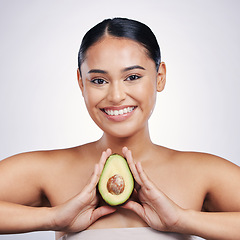 Image showing Happy woman, portrait and avocado in natural beauty, skincare or cosmetics against a white studio background. Face of female person smile, fruit or vegetable in healthy nutrition, fiber or wellness