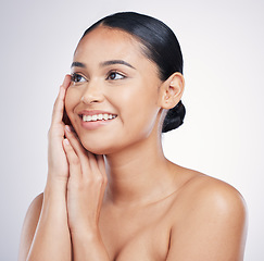Image showing Beauty, smile and woman with hands on face in studio for glow, dermatology or natural cosmetics. Happy aesthetic model person thinking of self care, facial or skincare results on a white background