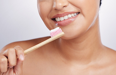 Image showing Teeth, smile and woman with toothpaste on toothbrush, dental and oral hygiene isolated on studio background. Female model, happy with mouth care and cleaning, fresh breath with health and closeup