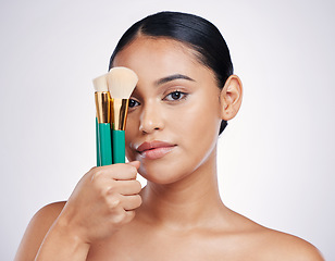 Image showing Makeup brush, face and beauty with woman in portrait, foundation product and powder isolated on studio background. Female model, natural cosmetics and skin glow with cosmetic tools and cosmetology